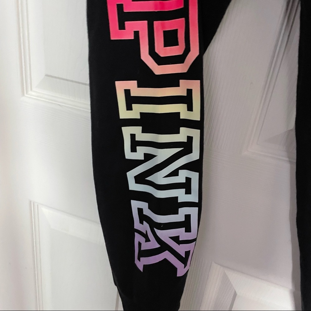 Pink sweatpants with rainbow “pink” on leg